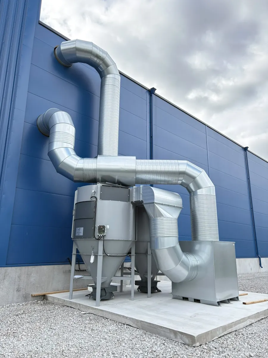 Dust extractor mounted on the outside wall of a new building