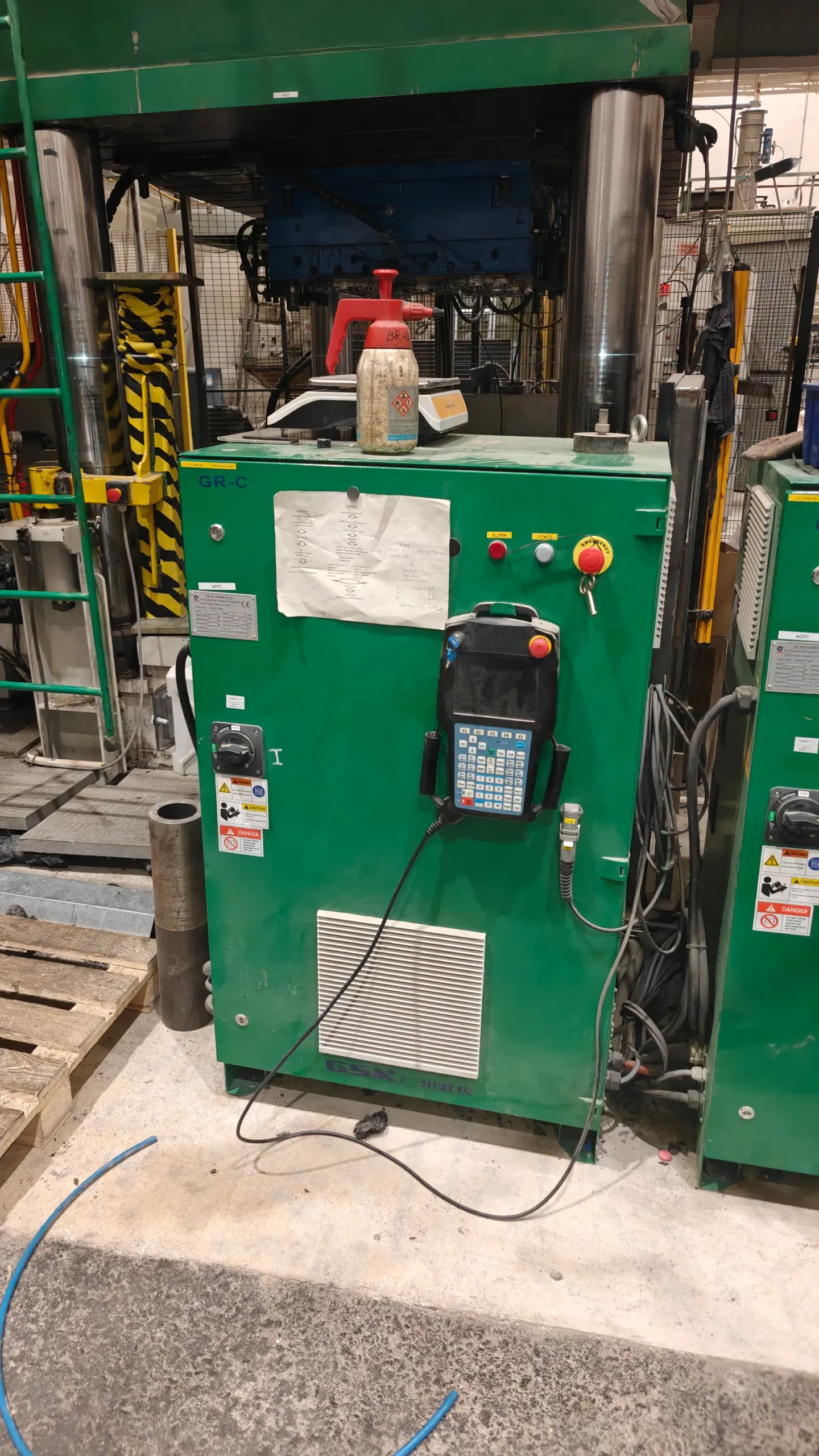 Robot controller cabinet with teach pendant on a production line
