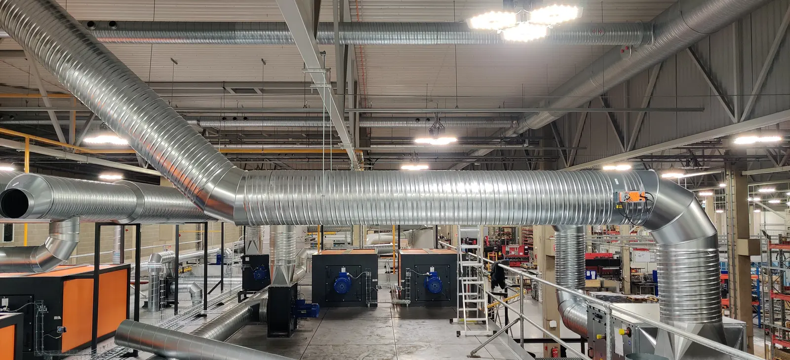 Ductwork and extraction units installed in a production hall