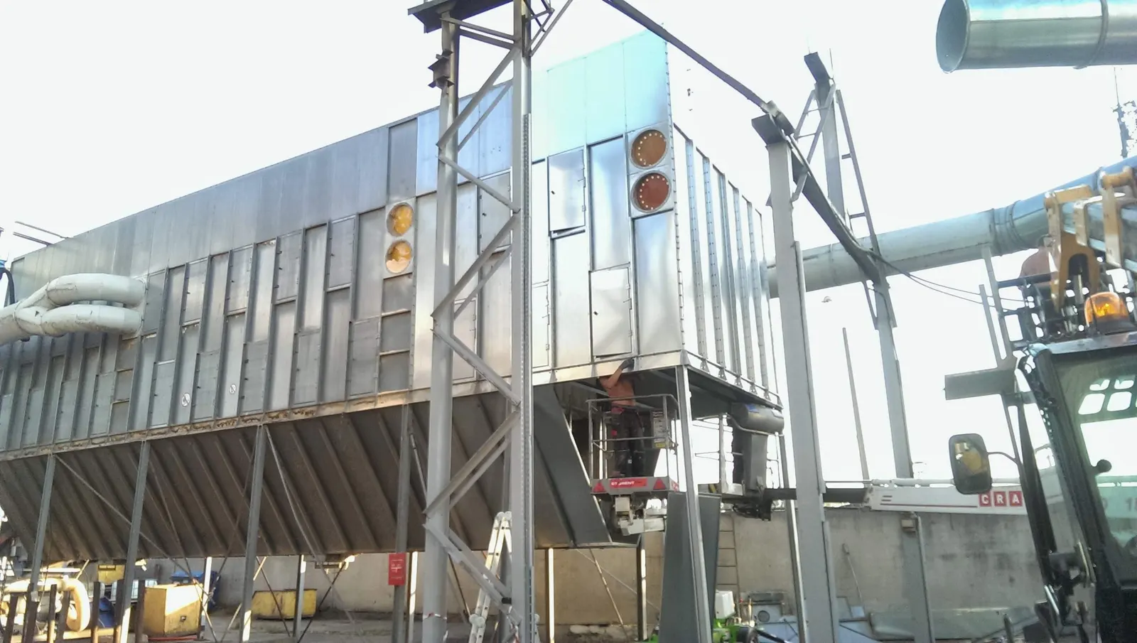 Ductwork sections and a telehandler on site, Riga 2014